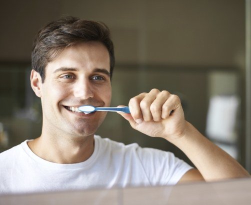 Man brushing teeth to preventive dental emergencies
