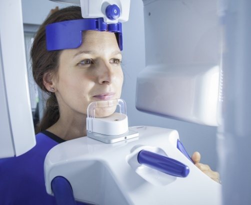 Woman receiving C B C T cone beam digital x ray scans
