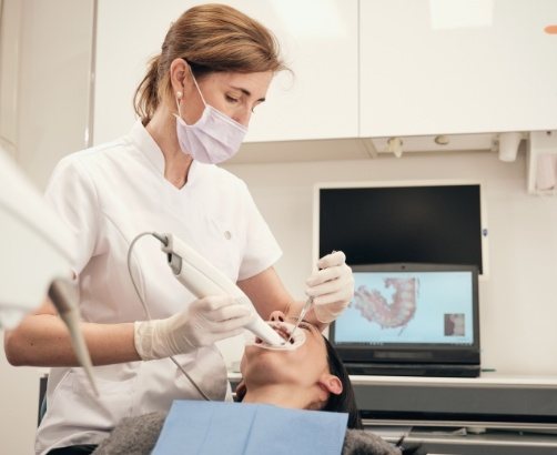 Dentist using digital impression system to capture bite impressions