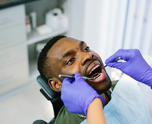 a dentist examining a patient’s mouth