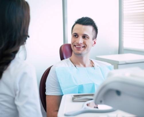 Man smiling during preventive dentistry checkup and teeth cleaning visit