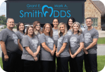 The Grant E and Mark A Smith D D S team in front of dental office