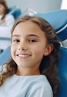 a child smiling during a dental checkup and cleaning