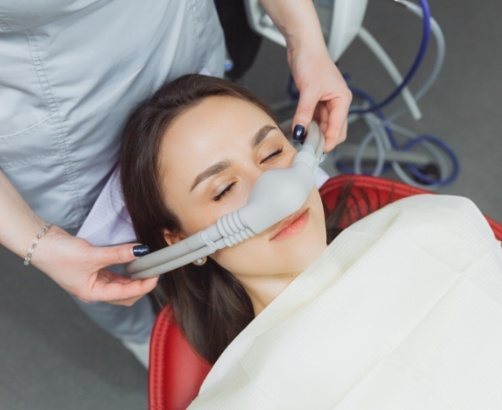 Dental patient receiving nitrous oxide sedation dentistry treatment