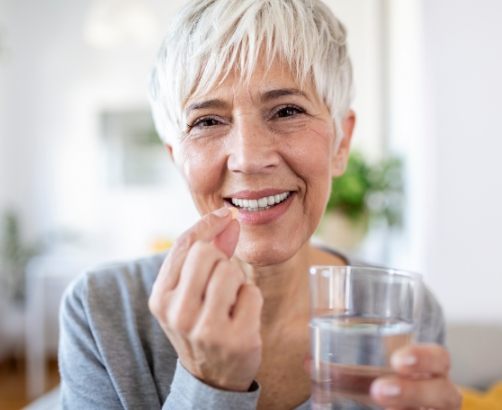 Woman taking oral conscious dental sedation pill