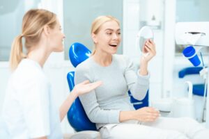 Woman admiring her cosmetic dental treatment
